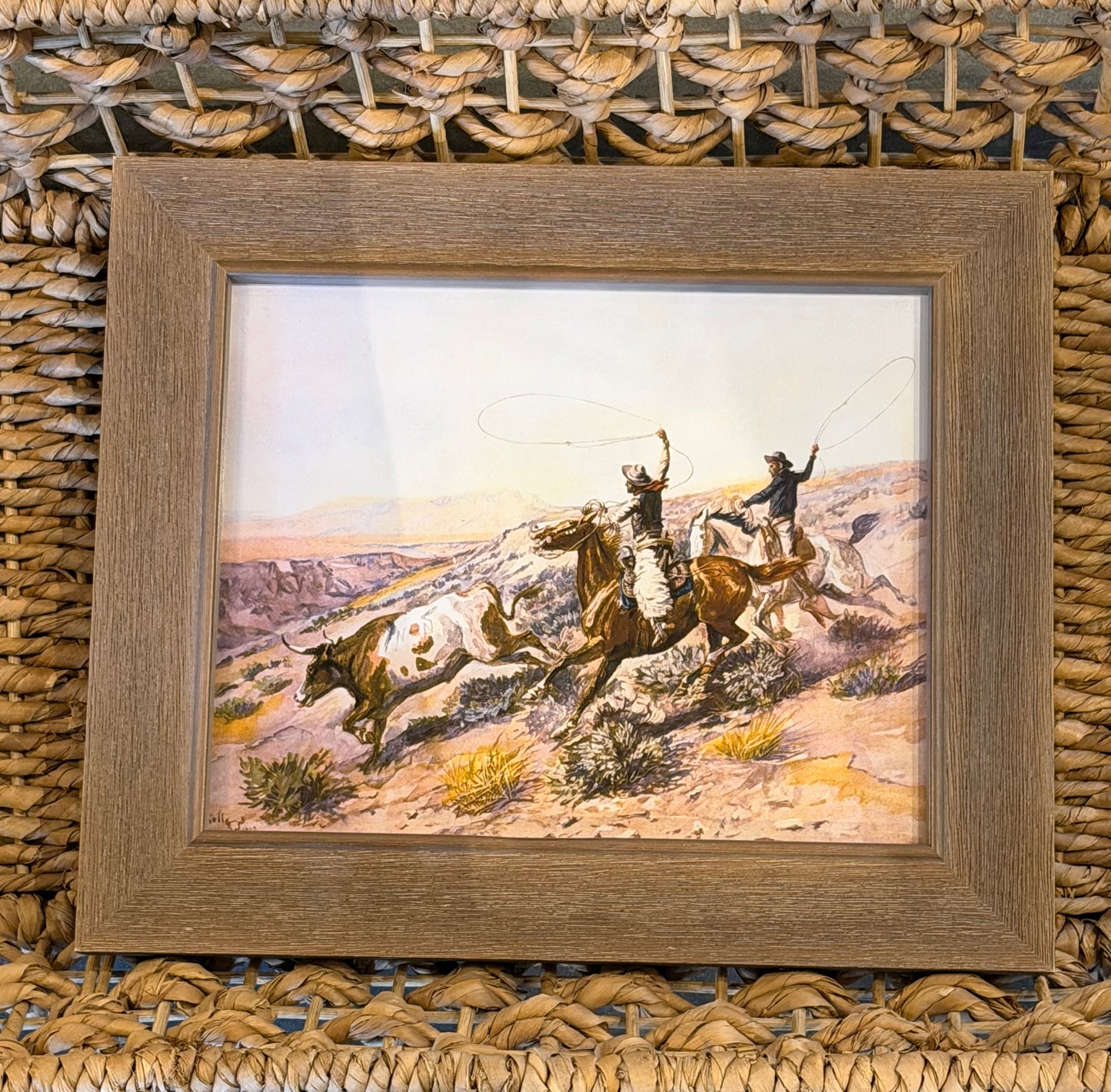 Vintage oil painting of cowboys roping cattle